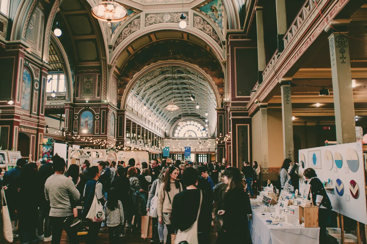 Visitors fill a grand exhibition hall.