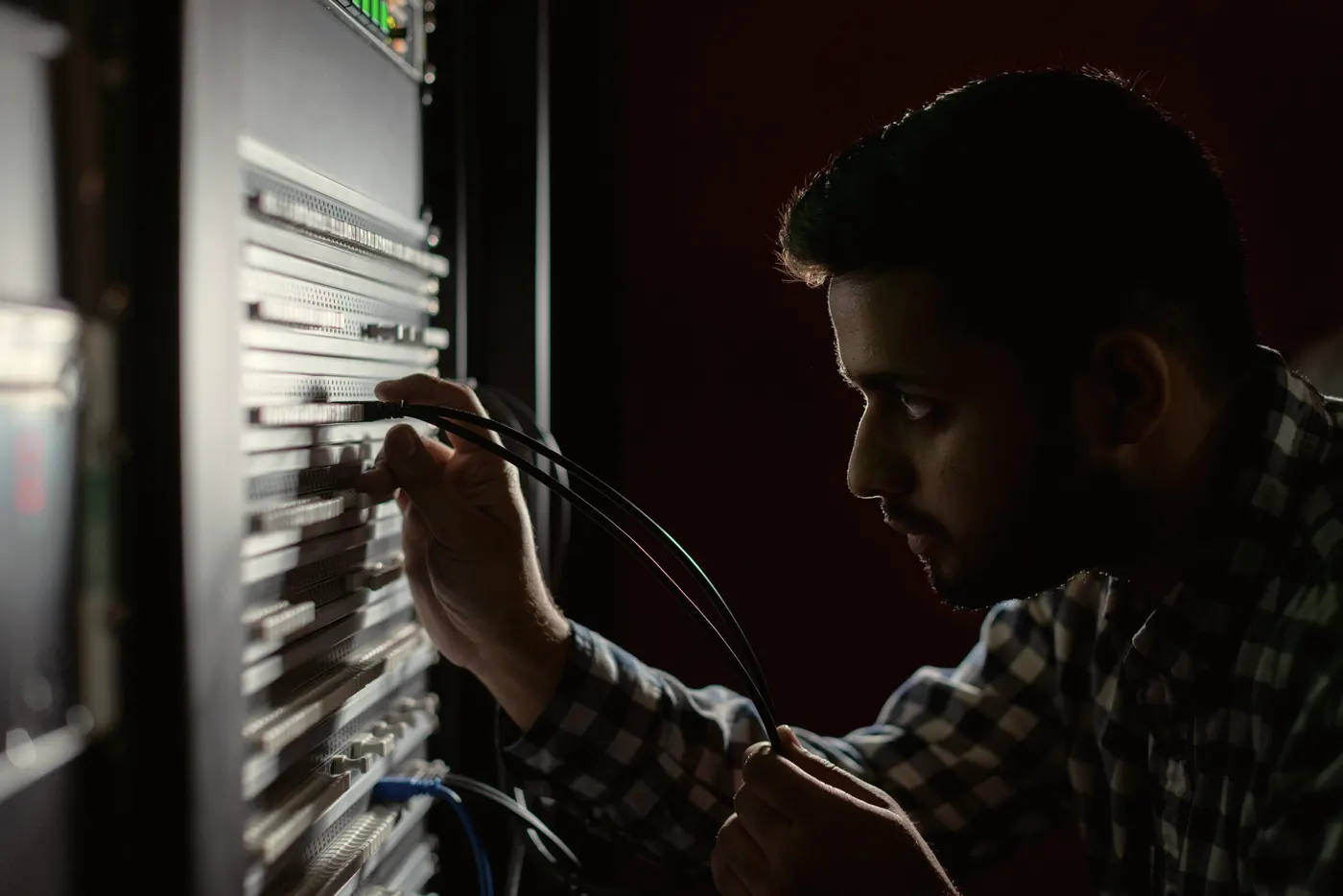 A technician works at a server rack.